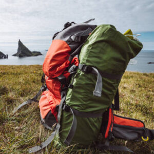 Lightweight hiking backpack resting beside a mountain trail.