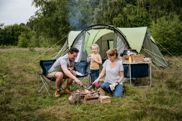 Large family camping tent set up at a scenic campground surrounded by trees.