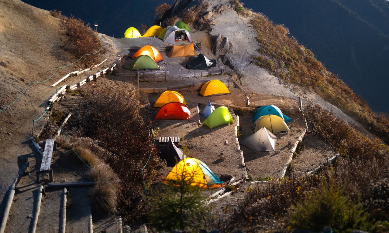 Aerial view of vibrant camping tents in the scenic Japanese Alps.